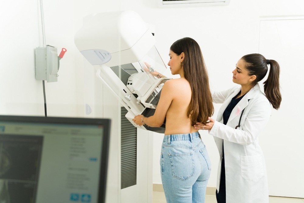 Rear,View,Of,An,Hispanic,Young,Woman,Getting,A,Mammogram
